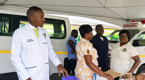 Valentine Golden Ghanem - Briefing the Cocoa Clinic team beside the ambulance at an outreach tent.