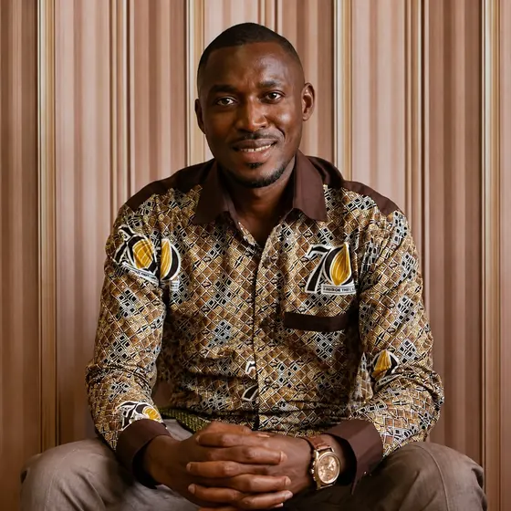 Valentine Golden Ghanem - Seated portrait, Ghana COCOBOD 70th Anniversary patterned shirt.
