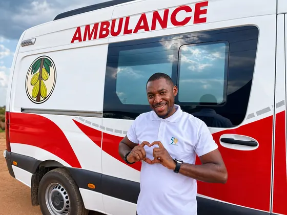 Valentine Golden Ghanem - Beside the Cocoa Clinic ambulance, hands forming a heart.